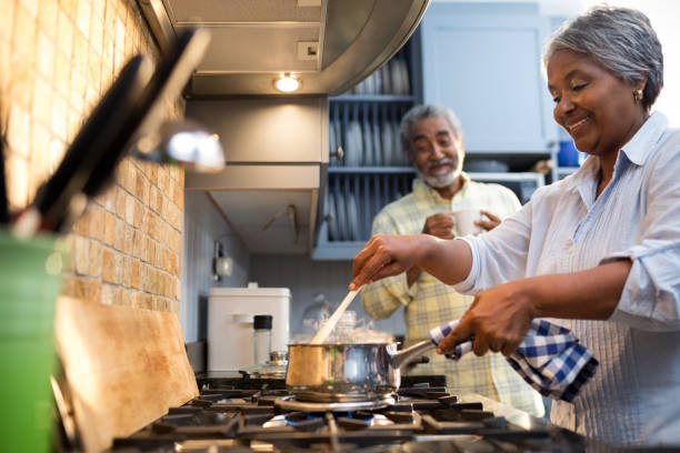 istock Smiling couple preparing food in kitchen 847680808