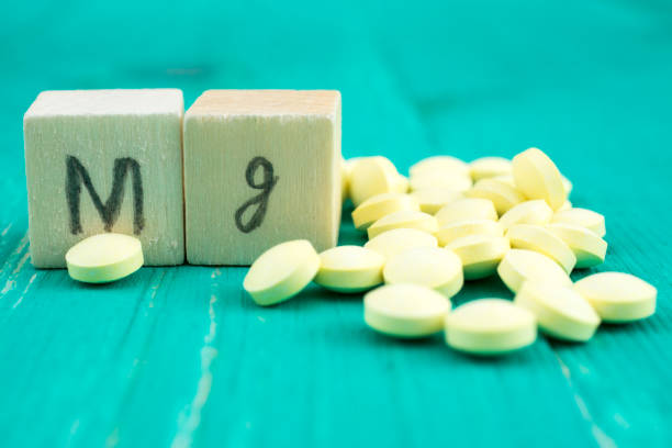 istock Yellow pills and wooden cubes symbolizing magnesium 847681070