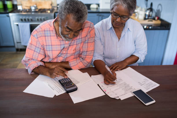 High angle view of couple using calculator
