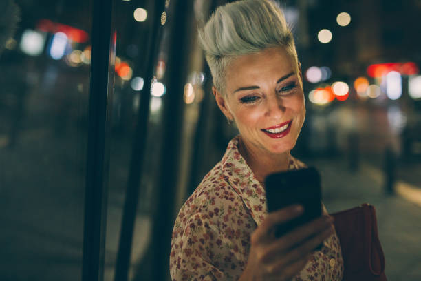 istock Elegant woman texting at night 847683380