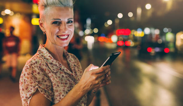 istock Elegant woman texting at night 847683408