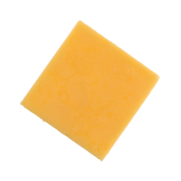 Square of gouda cheese on a white background Top view of a square gouda cheese slice isolated on a white background. cheddar cheese stock pictures, royalty-free photos & images