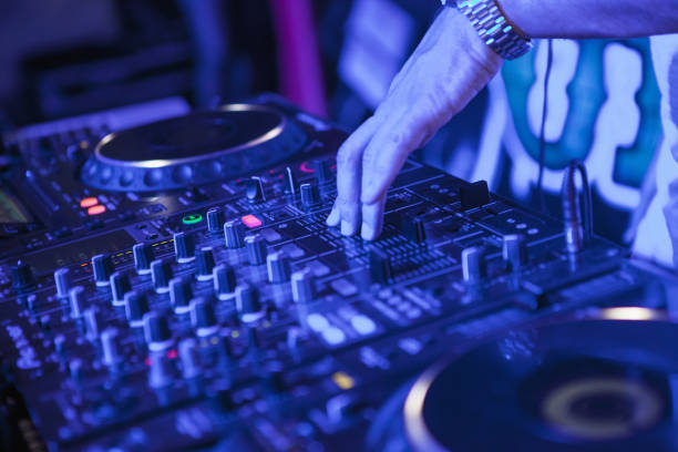 istock DJ playing music at mixer on colorful blurred background 847694566