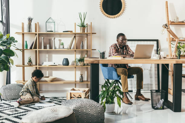 istock african american father and son in office 847694600