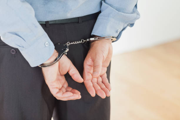 istock Hands of businessman with handcuffs 847695136