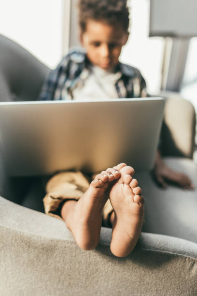 istock boy with laptop in armchair 847698454