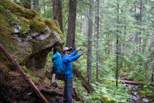 istock Male hiker using virtual reality headset in the forest 847698630