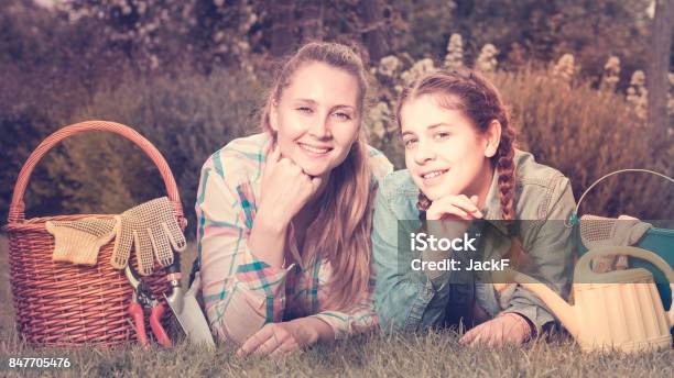 Young Mother And Dauther With Gardening Tools In Outdoors Stock Photo - Download Image Now