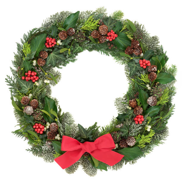 Christmas Wreath Decoration Christmas wreath decoration with a red bow, holly, mistletoe, snow covered juniper fir, blue spruce, cedar, pine cones  and ivy leaves on white background. wreathe stock pictures, royalty-free photos & images