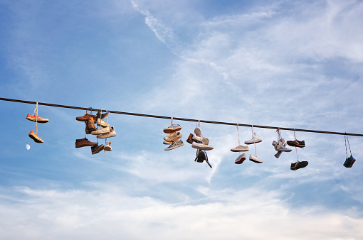 Shoes hanging on an electric cable
