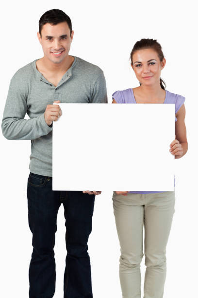 istock Young couple holding banner together 847710010