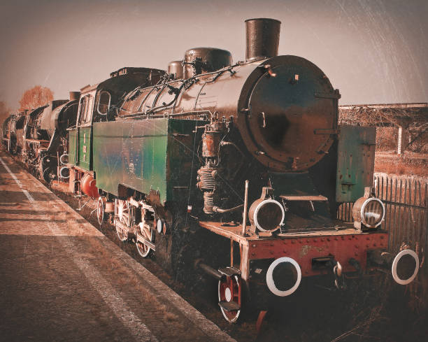 The old locomotive stands on the railway. Stylized toned photo.