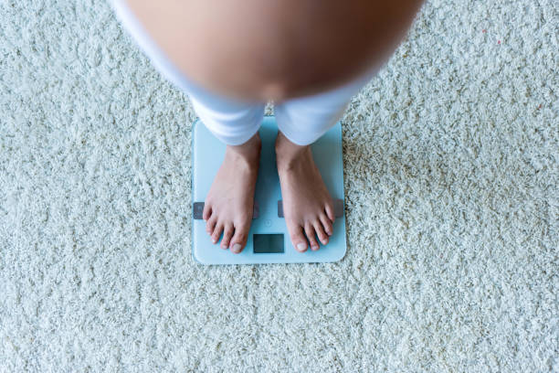 istock pregnant woman standing on scales 847721580
