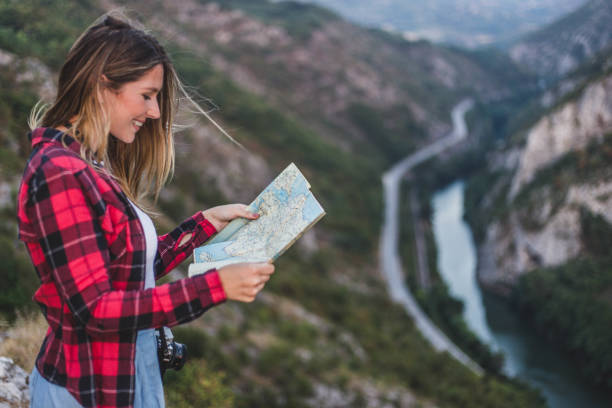 istock Hippie woman with map on viewpoint 847730908