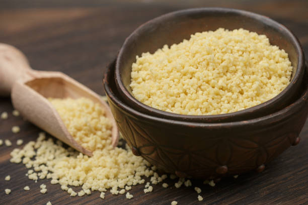 istock Raw organic couscous in a bowl on the table. Selective focus 847731078
