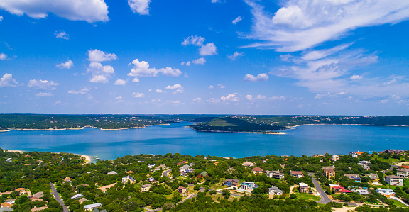 aerial view above Lake Travis and Lakeway Homes along Water's Edge