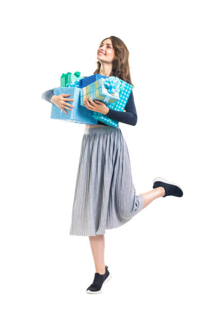 istock Happy beautiful woman in motion holding gift boxes 847731390