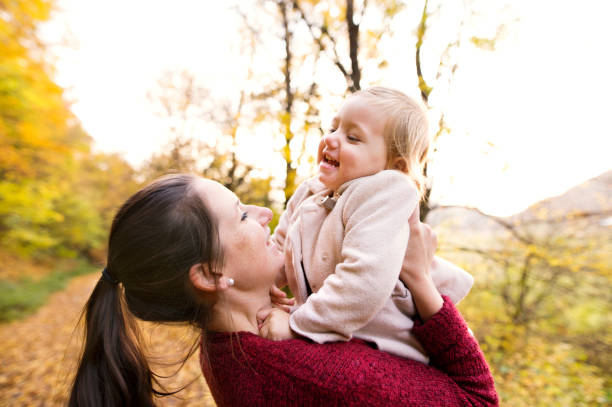istock Mother and daughter on a walk in autumn forest. 847737822