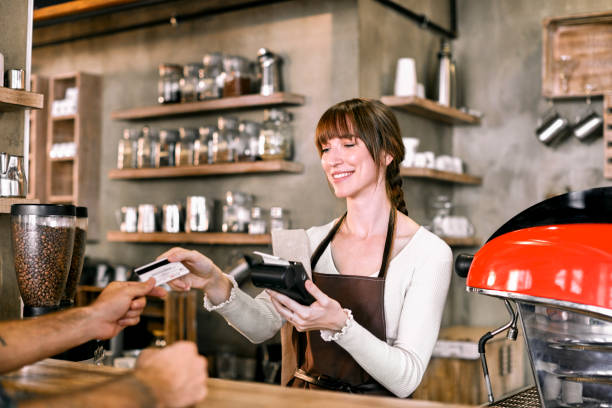 istock Staff Serving Customer In Busy Coffee Shop 847741864