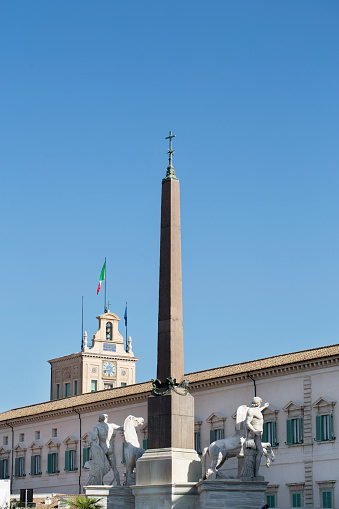 Italy, Rome - September 2017. Vertical view of Quirinale Obelisk with Palazzo del Quirinale in background