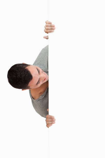 istock Young male looking around the corner 847744814