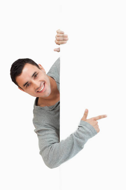 istock Smiling young male pointing around the corner 847744902