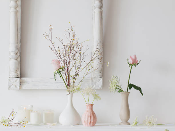 istock flowers in a vase and candles on white background 847751482