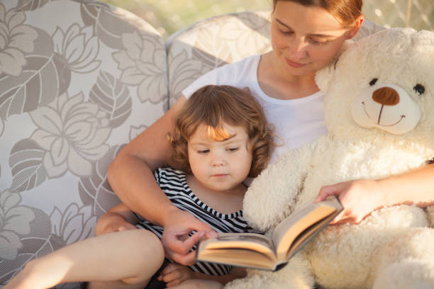 istock Mother and child reading book together. 847755118