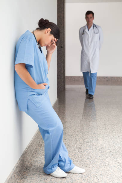istock Sad nurse leans against wall 847760350