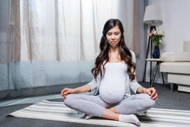 istock Pregnant woman sitting in lotus pose 847762804