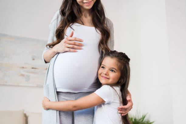 istock Girl hugging pregnant mother 847764284