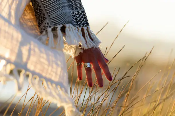 Photo of Woman hand caressing grass