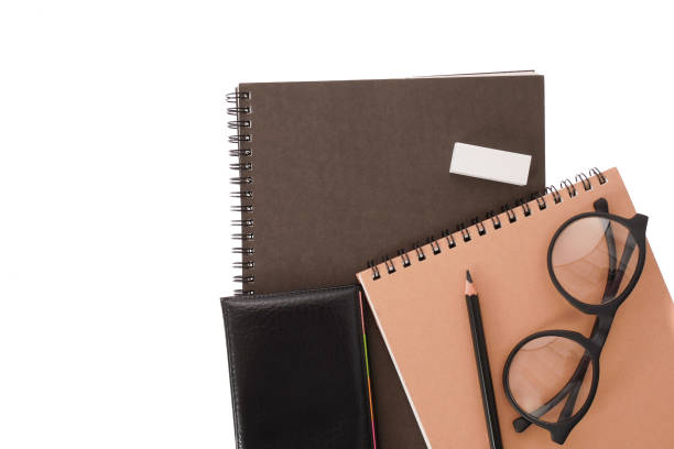 istock notebook black cover with pencil on white desk background 847793648