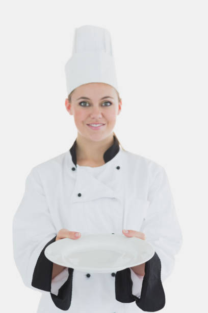 istock Woman in chef uniform showing an empty plate 847803850