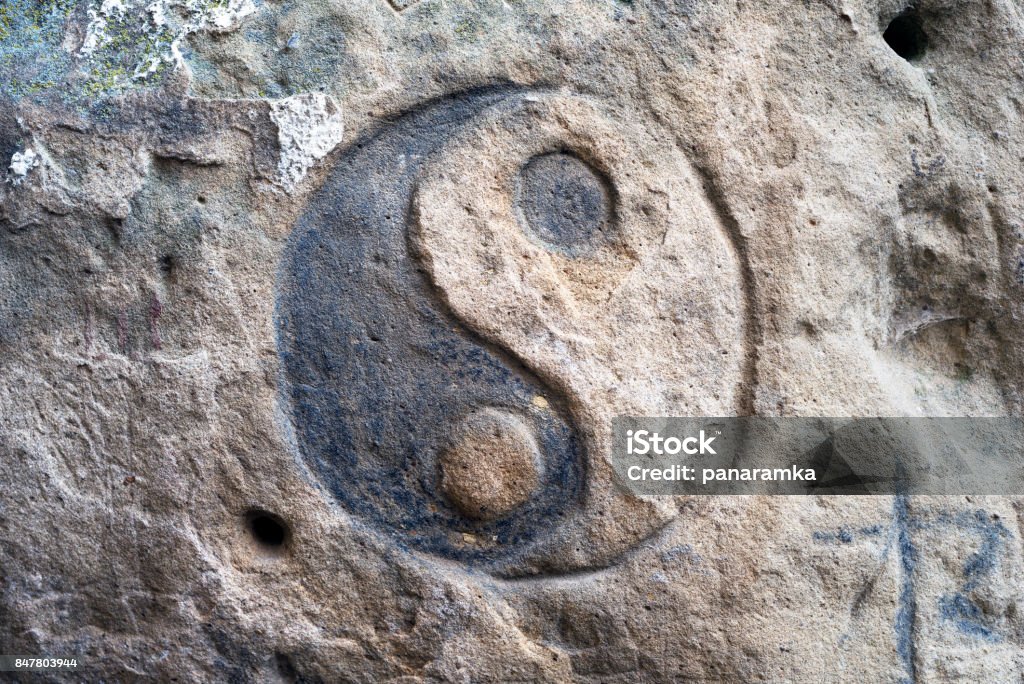 carvings on rocks in Bubnyshche Bubnyshche between the rocks - an ancient pagan temple, where tourists stop modern travelers and hippies left in their memory patterns on the stones on their faith and religion, yin and yang Abstract Stock Photo