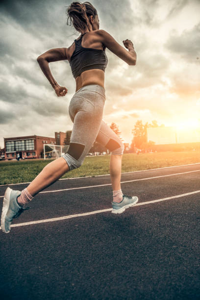 istock woman running on stadium track 847808074