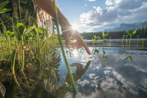 istock Finger touches surface of mountain lake 847810910