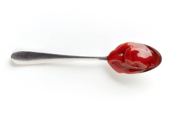 istock Ketchup in a spoon isolated on white, from above 847811084