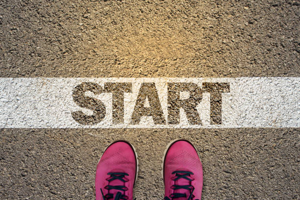 a person standing in the starting line - desert road fotos imagens e fotografias de stock