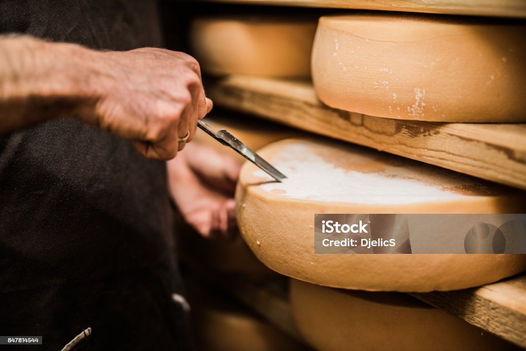 Frenchman taking a sample of premium quality cheese Cheese Stock Photo