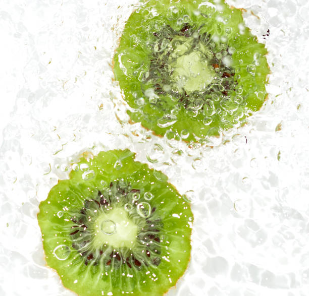 istock juicy kiwi fruit in water on a white background. macro 847814972