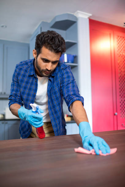 Man cleaning wooden table