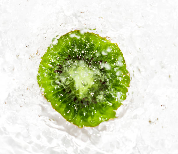 juicy kiwi fruit in water on a white background. macro