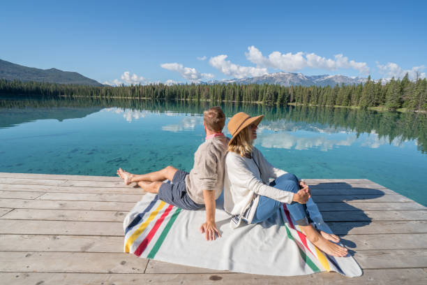istock Young couple relaxing on lake pier 847819006