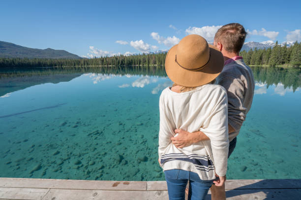 istock Young couple relaxing on lake pier 847819248