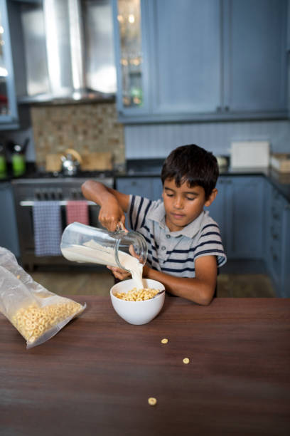 istock Boy pouring milk in cereals 847822634