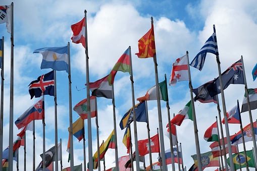 Flags from different countries around the world waving