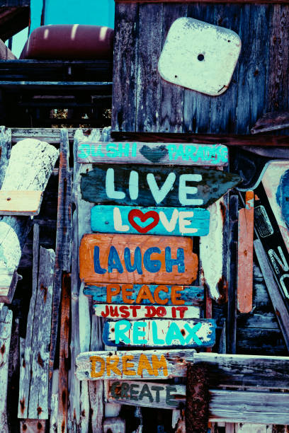 A wooden sign created out of driftwood from the beach.  Painted with words to create an inspirational​ feeling.