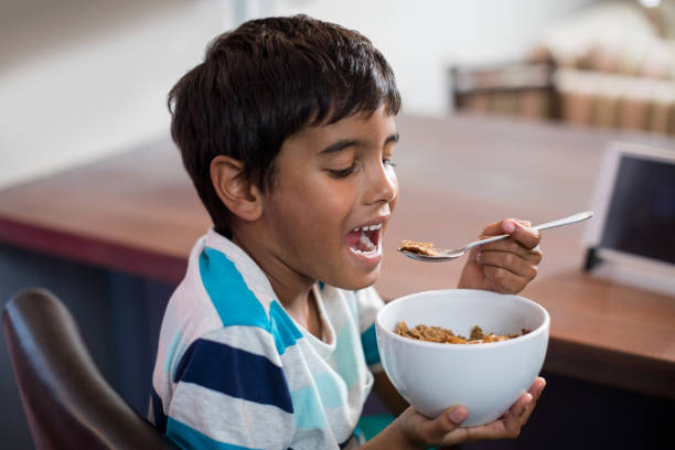 istock Close up of boy having cereal breakfast 847829304