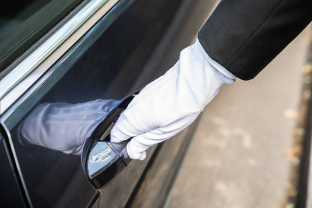 Male Chauffeur Opening Door Of Car Close-up Of A Male Chauffeur Pulling A Car's Door Handle door attendant photos stock pictures, royalty-free photos & images